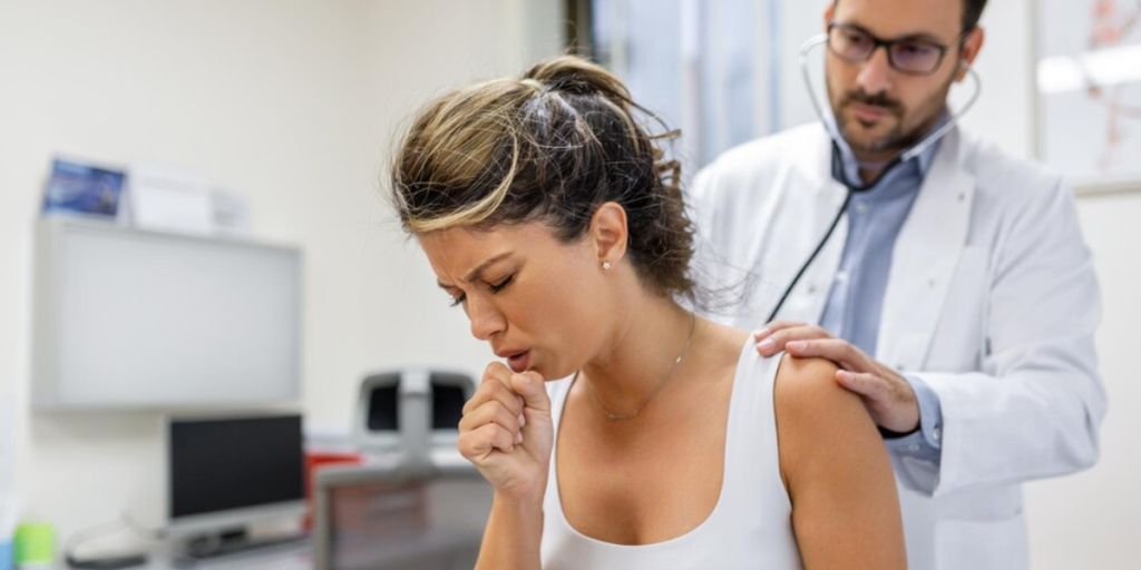 Woman having doctor check her cough brought on by VOCs.
